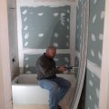 DAY FOUR Bathroom Remake, Tuesday Shower wall panels going up.