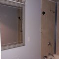DAY SIX Bathroom Remake, THURSDAY Light fixtures and mirrors go up! Caulking in corners of shower walls.